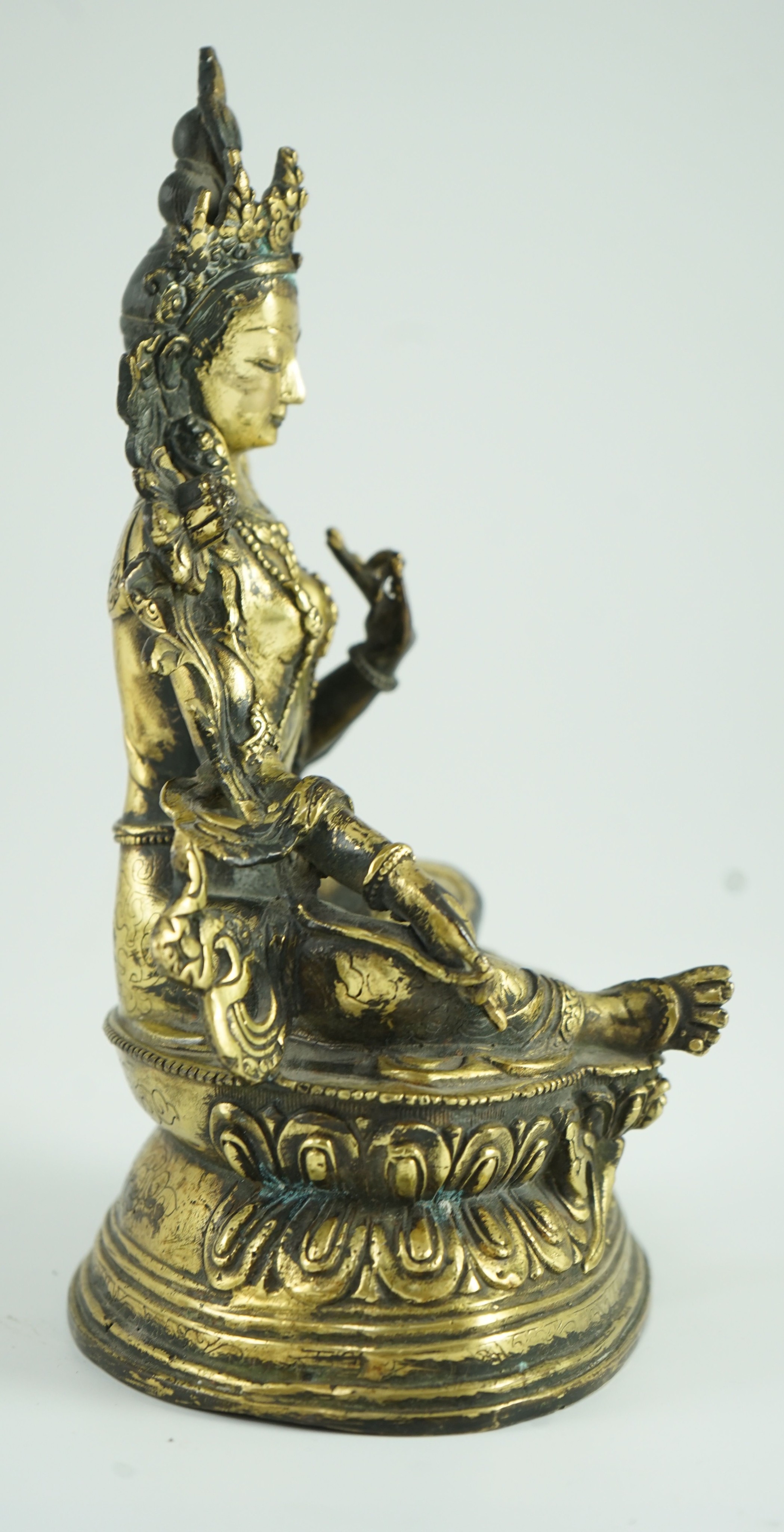 A Sino-Tibetan bronze seated figure of Green Tara, 23.5 cm high